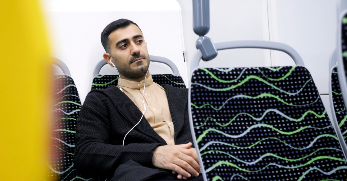 Man on the bus listening to music