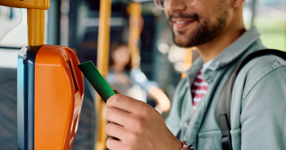 Passenger tapping an electronic card while riding in public transport