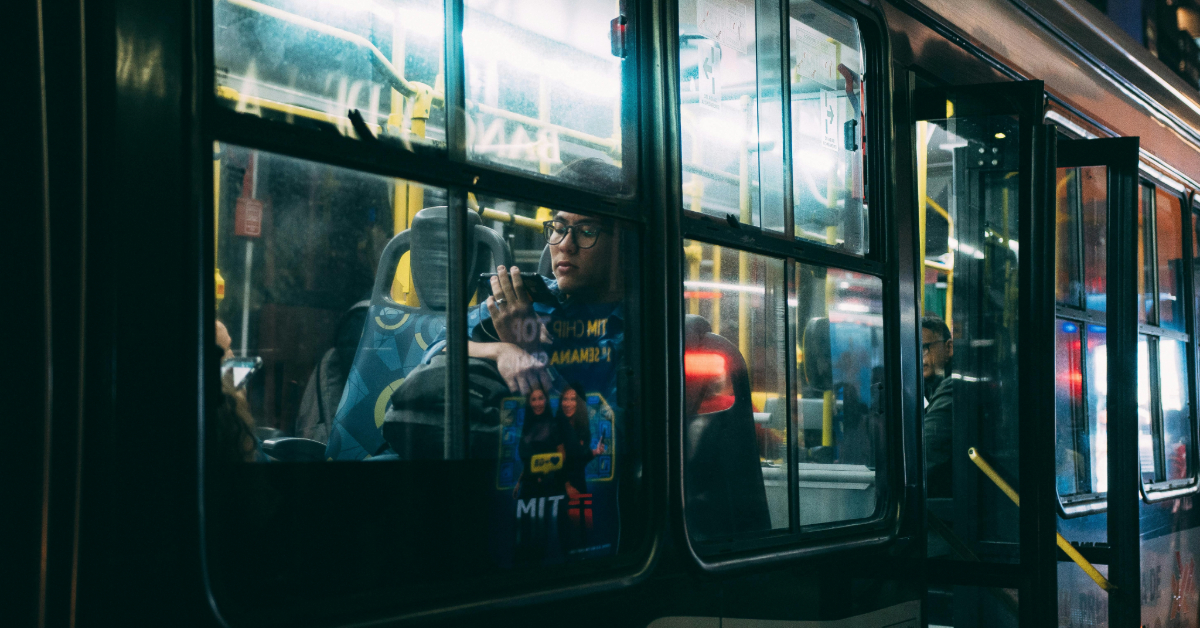 People sitting inside the F14 bus at night