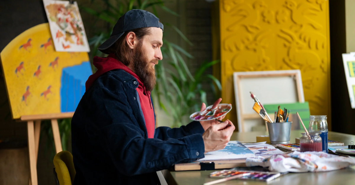 An artist painting in his studio