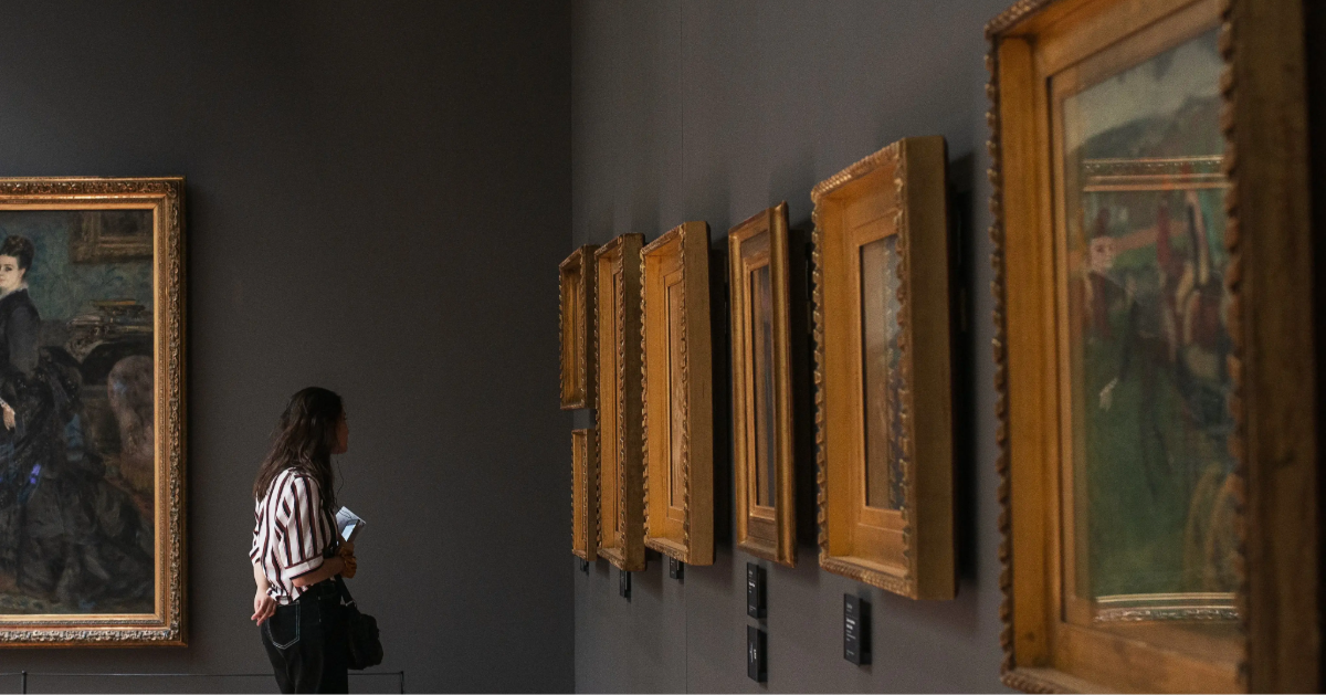 A woman selecting a piece for art investment