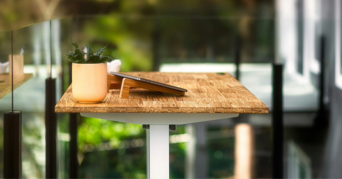 An open balcony featuring a wooden table adorned with a small potted plant