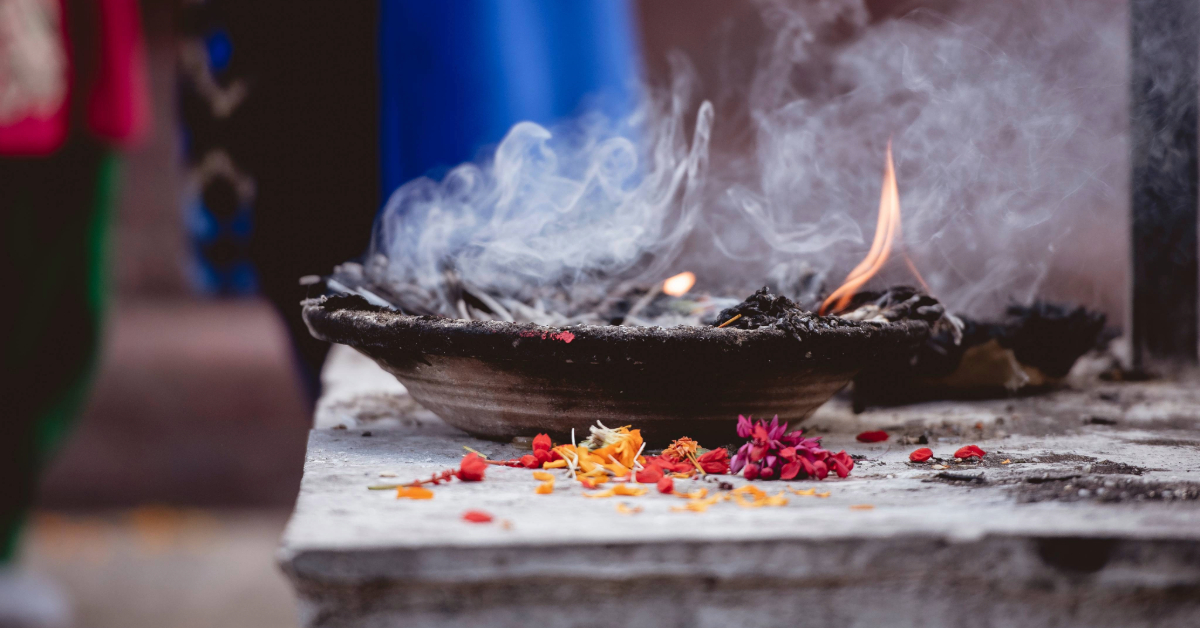 A close-up shot of a burning aarti plate