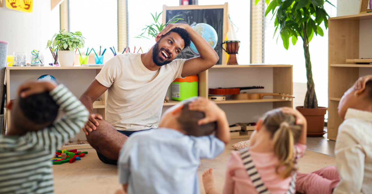 Nursery school children with a teacher in the classroom, doing an exercise.