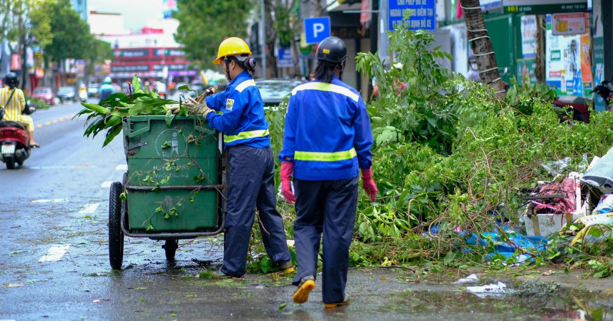 Workers collecting trash from the road