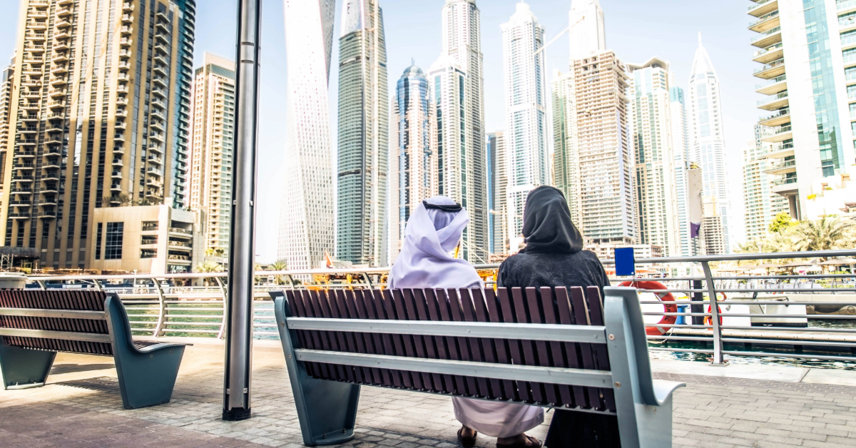 couple enjoying time on a bench in the marina