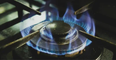 A close-up shot of a gas burner producing a blue flame.