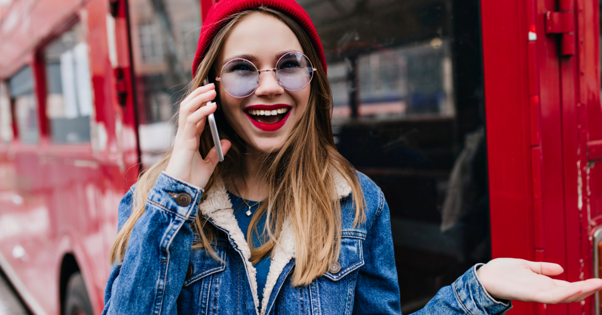 A woman getting down from the F19B bus while talking on her phone