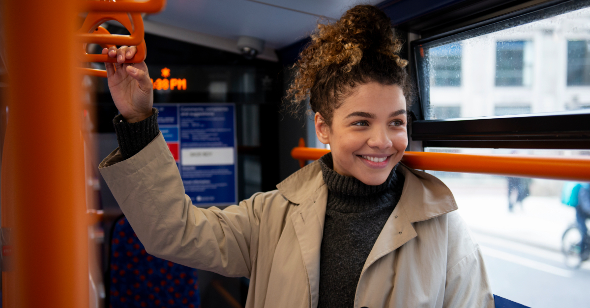 A woman standing inside the F13 bus