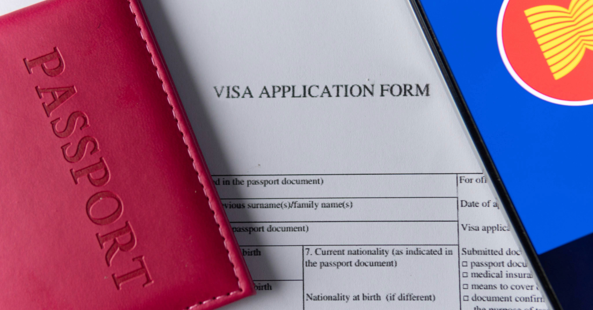 A passport, a visa application form, and a smartphone