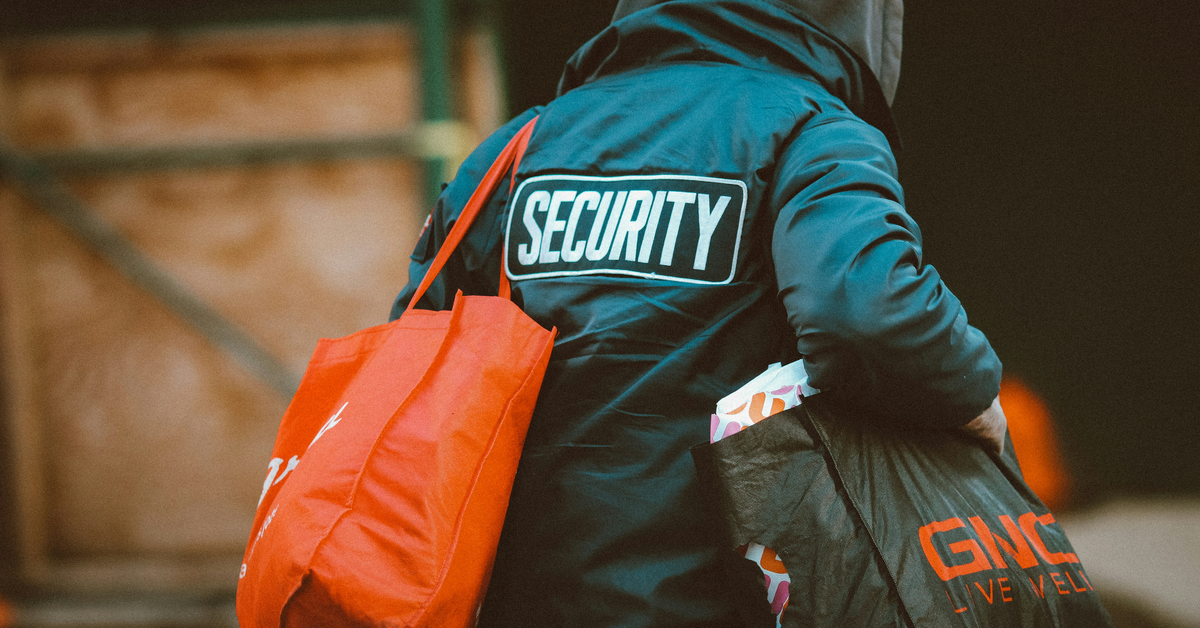 A man wearing a security jacket