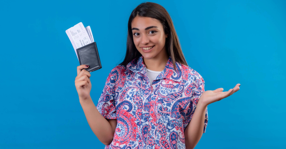 A woman holding her passport, visa, and boarding pass