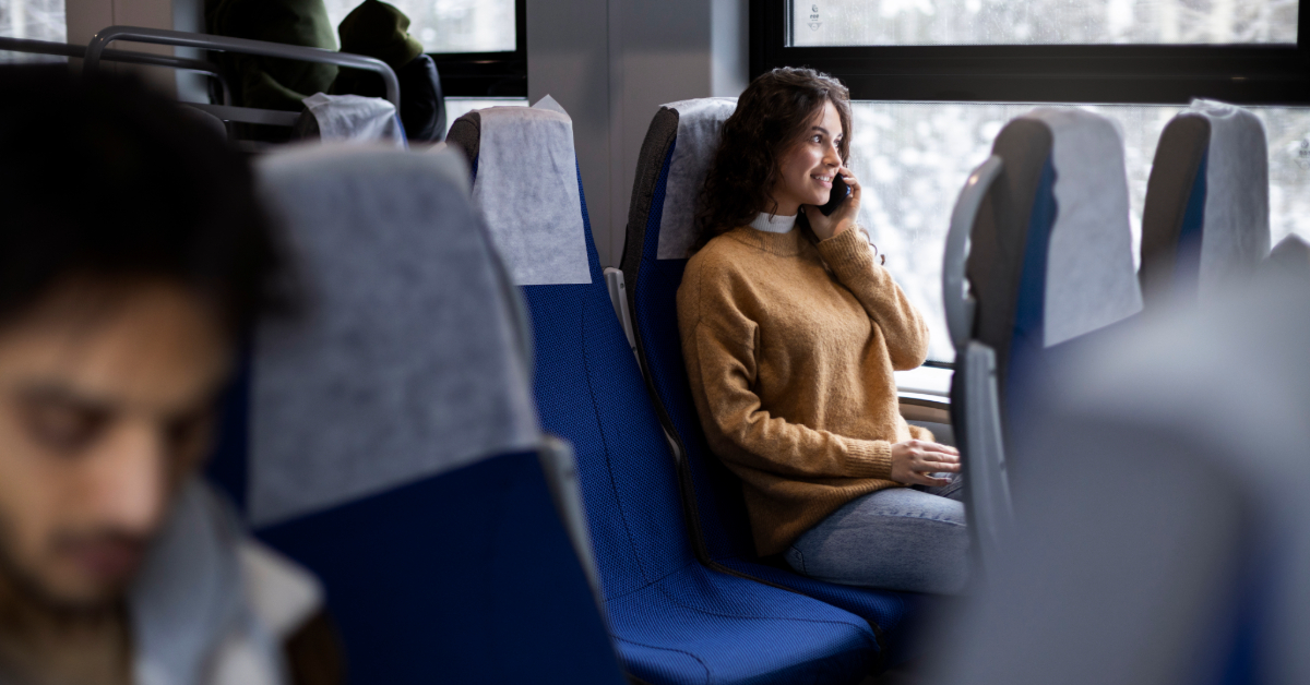A woman talking on her phone inside the F15 bus