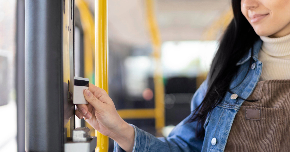 tapping her card on the bus reader to board