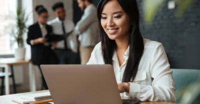 A woman working on her laptop at her workplace
