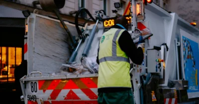 A worker collecting trash from the Take My Junk UAE company