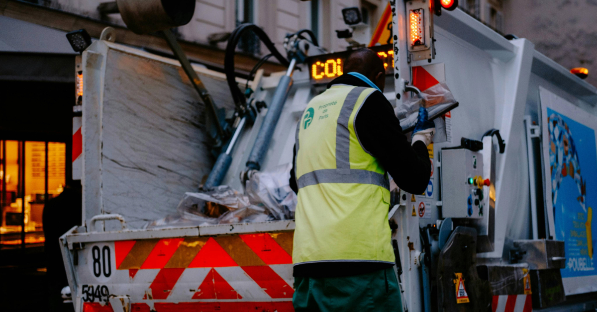 A worker collecting trash from the Take My Junk UAE company