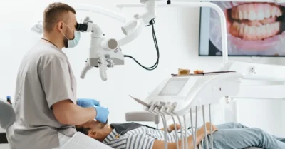 A dentist examining a patient’s teeth in a dental treatment room