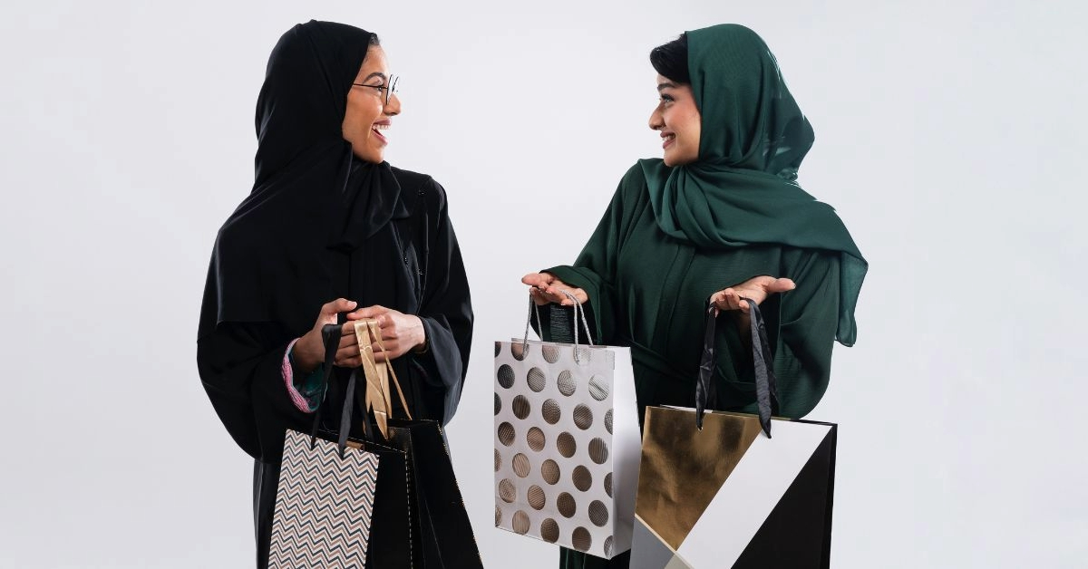 Two Arab women holding shopping bags 