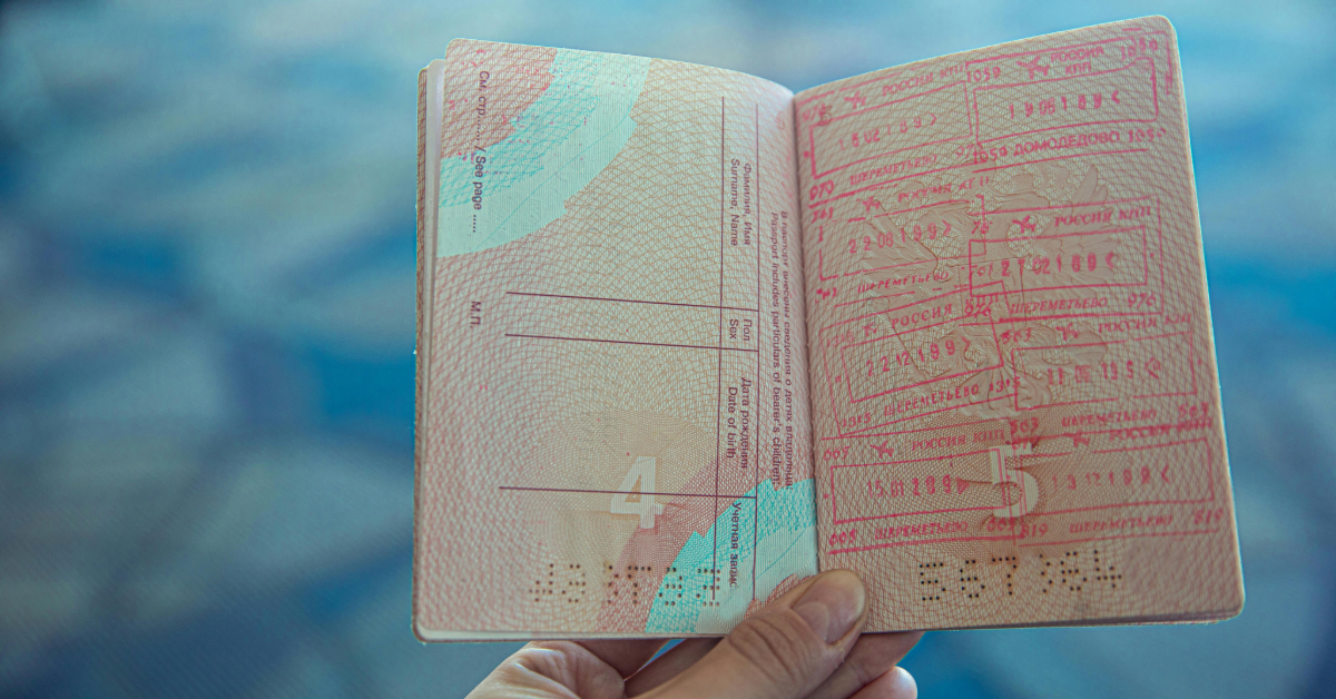 A person holding their Dubai passport open in their hands