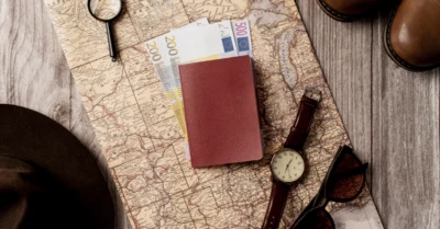 Iceland visa kept in a table along with money, a watch, and sunglasses