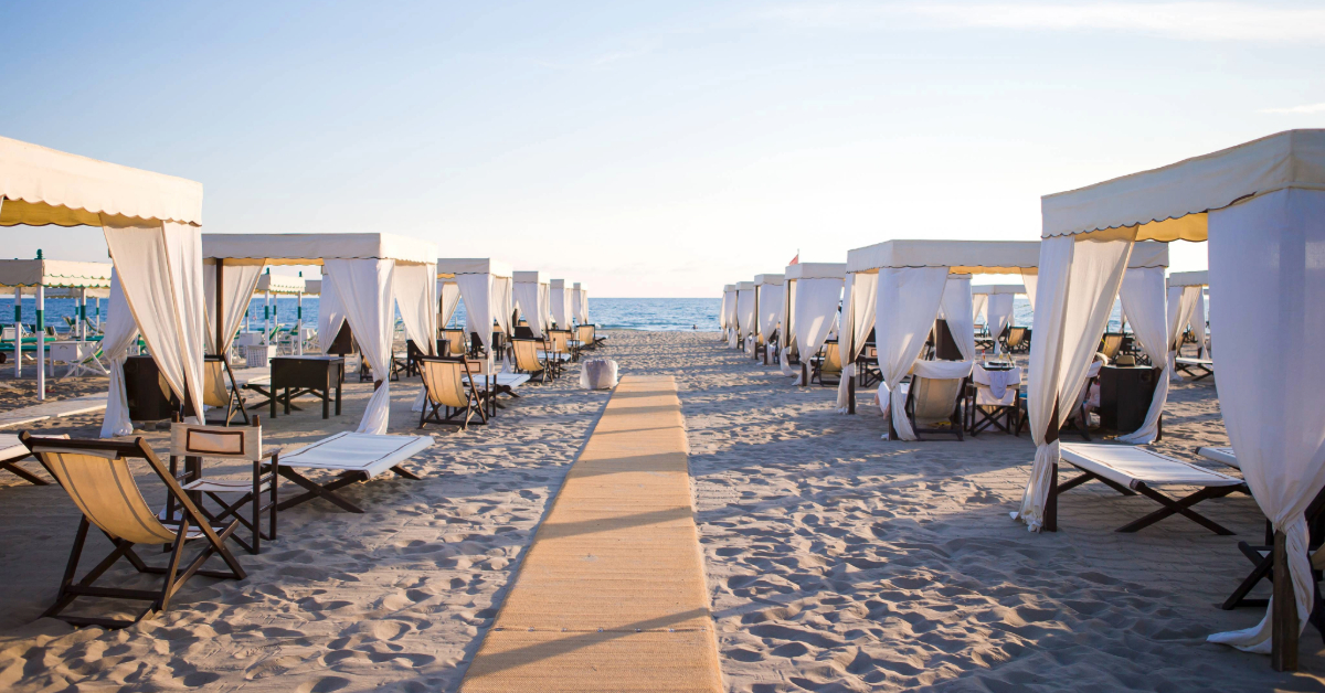 Wooden sunbeds in front of a turquoise sea