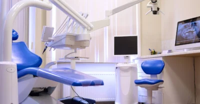 A dental examination private room with a chair and equipment