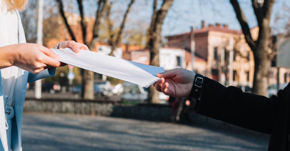 A landlord giving an eviction notice to their tenant