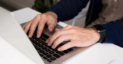 A man typing on his laptop