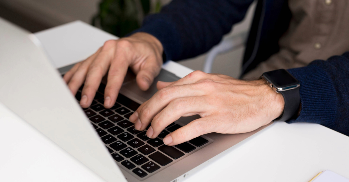 A man typing on his laptop