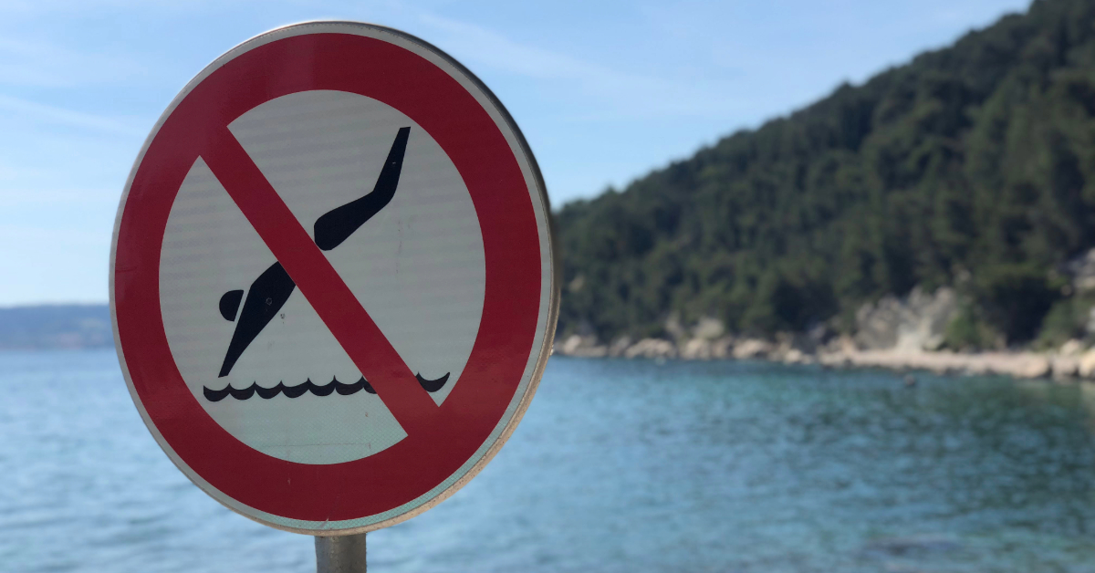 no diving sign in a beach