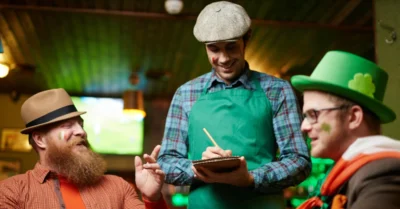 Two people enjoying St Patrick’s Day celebration at a Dubai restaurant