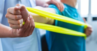 Physical therapist gives resistance band exercises
