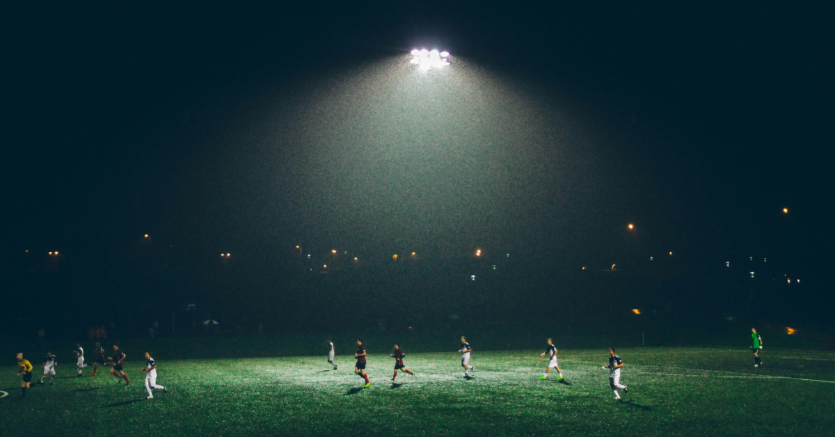 A team practising football at night.
