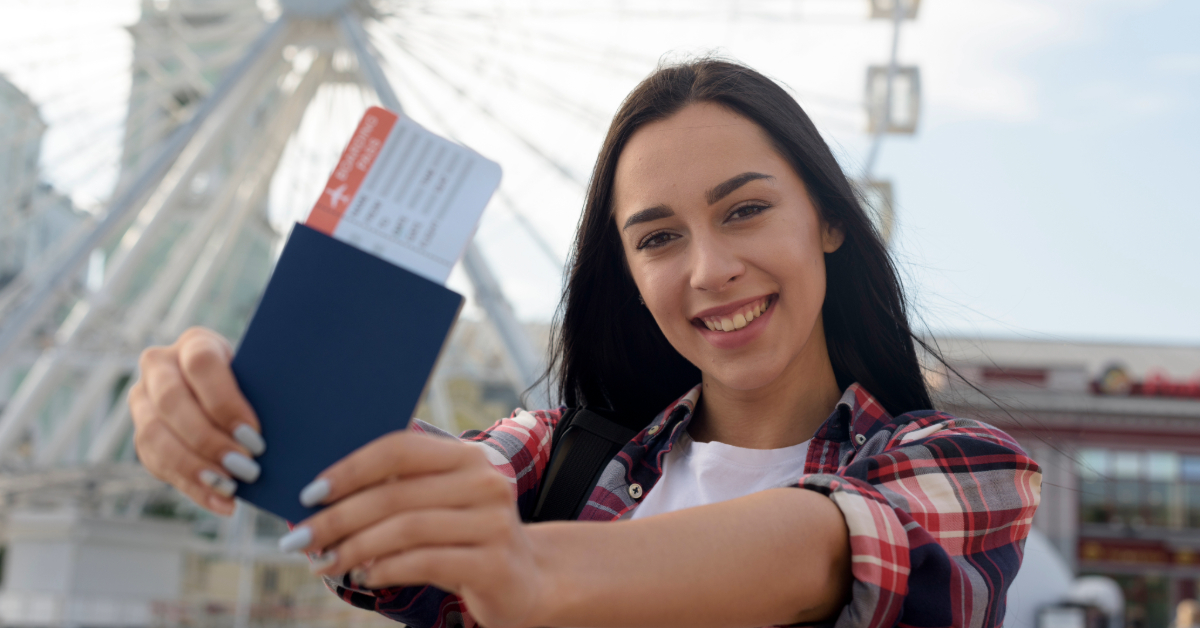 A woman holding her Ireland visa and boarding pass in both her hands
