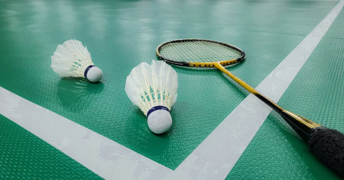Badminton equipment placed on the floors in a court