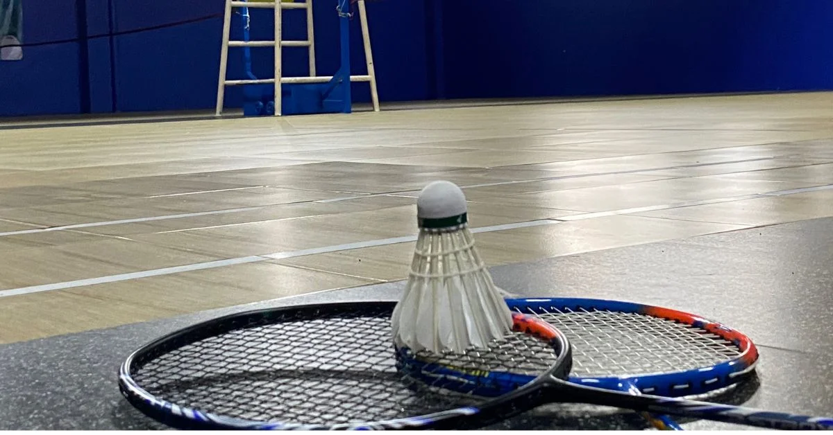Rackets and other badminton equipment on a courts' floor