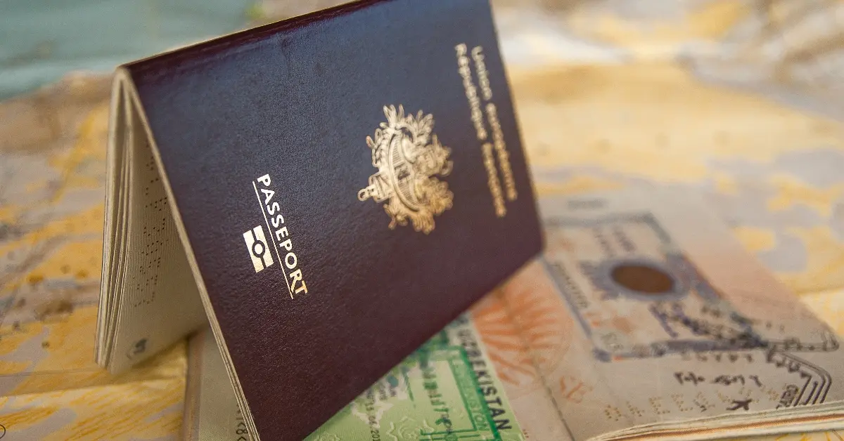 A passport and visa are placed on the table