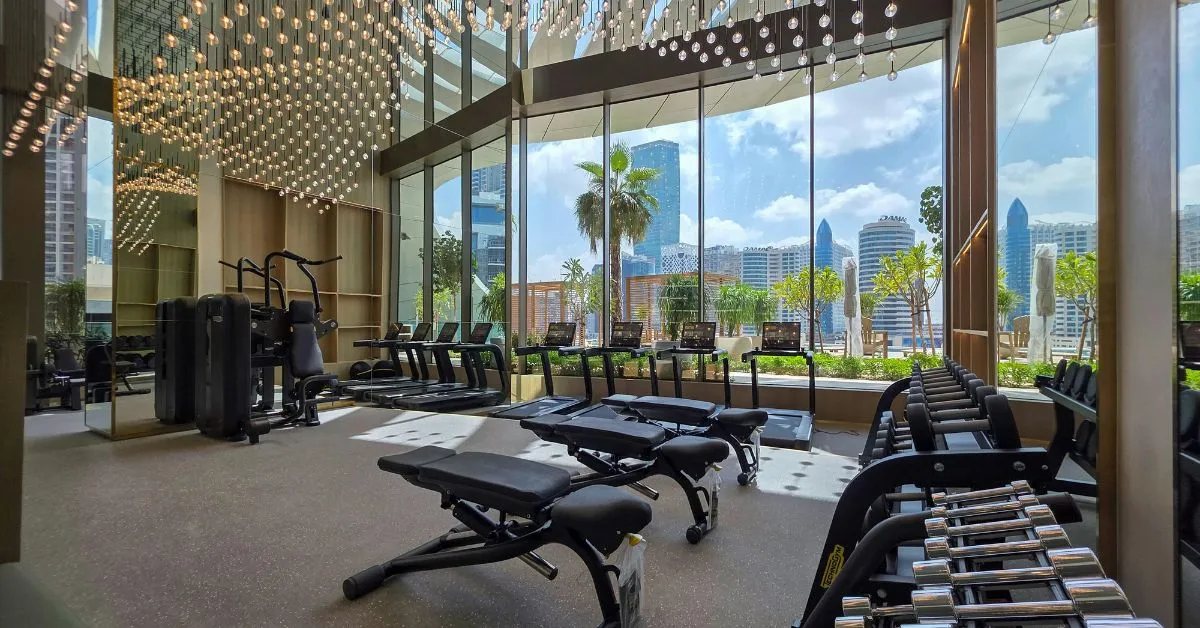 Luxury gym interior in DIFC with modern equipment and floor-to-ceiling windows