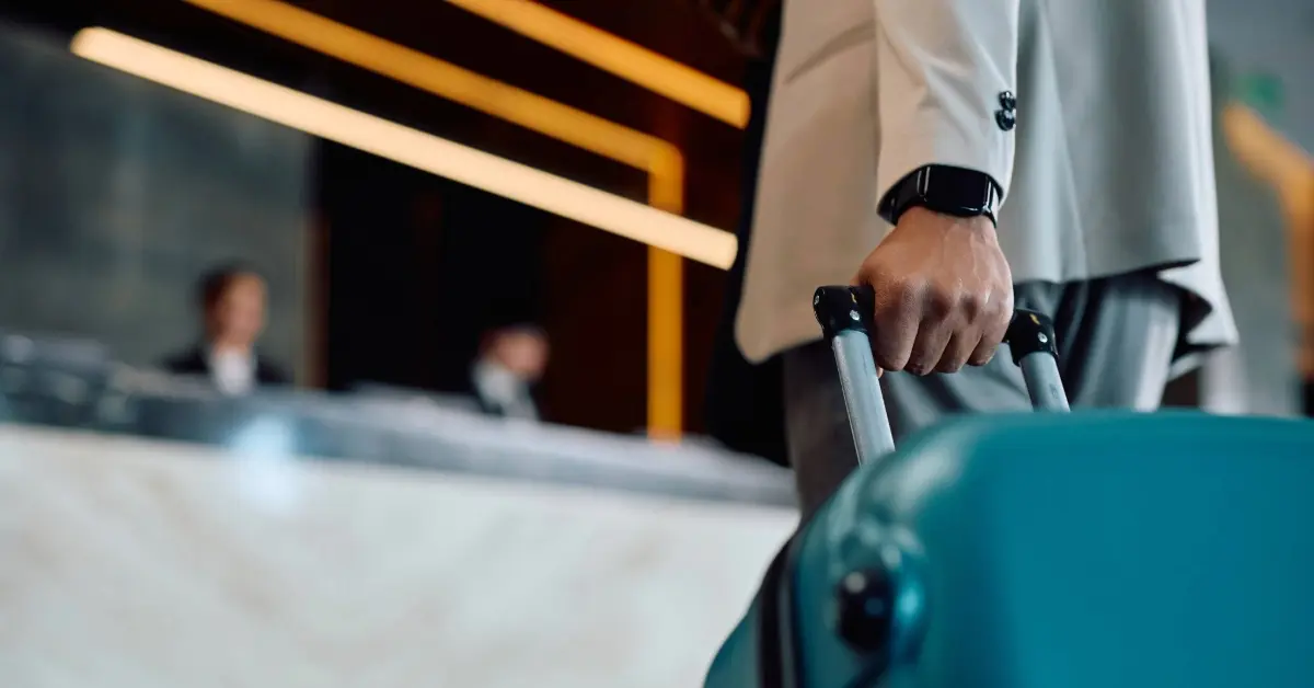 Man with a suitcase in a hotel lobby