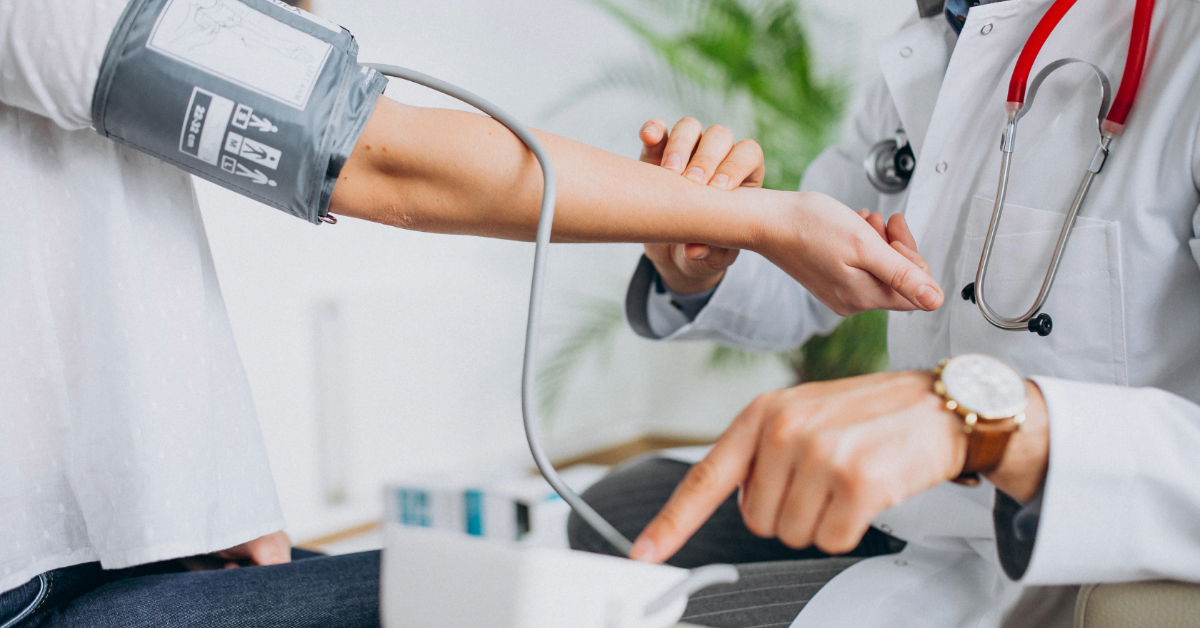A doctor measuring a patient’s blood pressure in a clinical setting