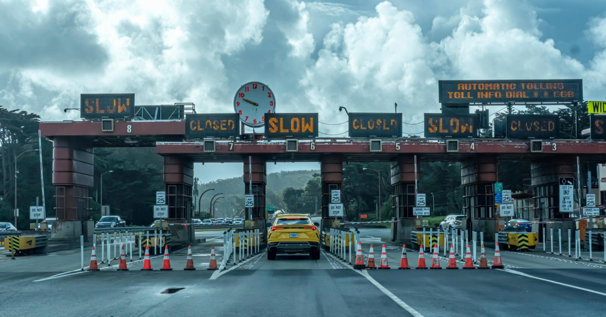 A taxi passing through a toll station