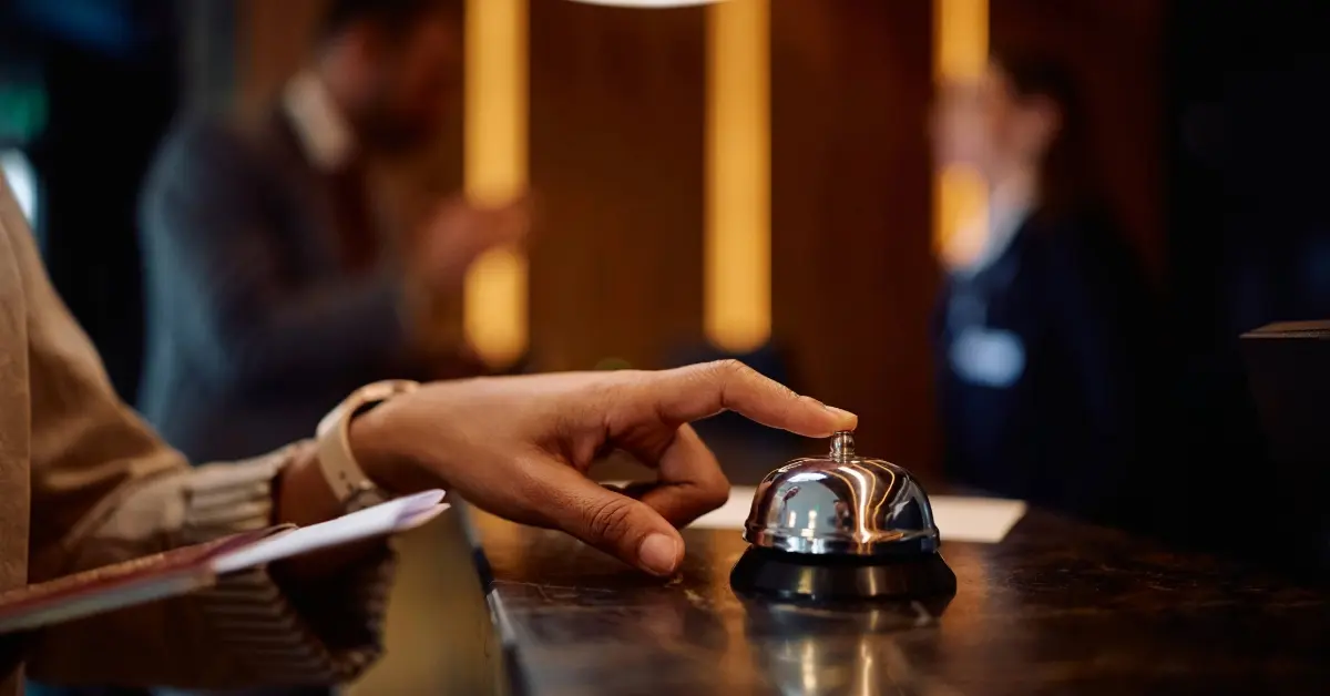 woman using service bell at a hotel lobby