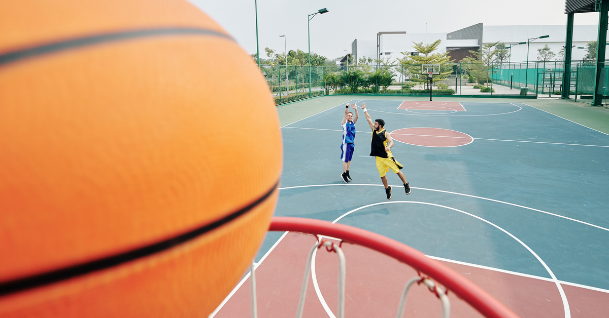 Basketball players celebrating after a successful play outdoors