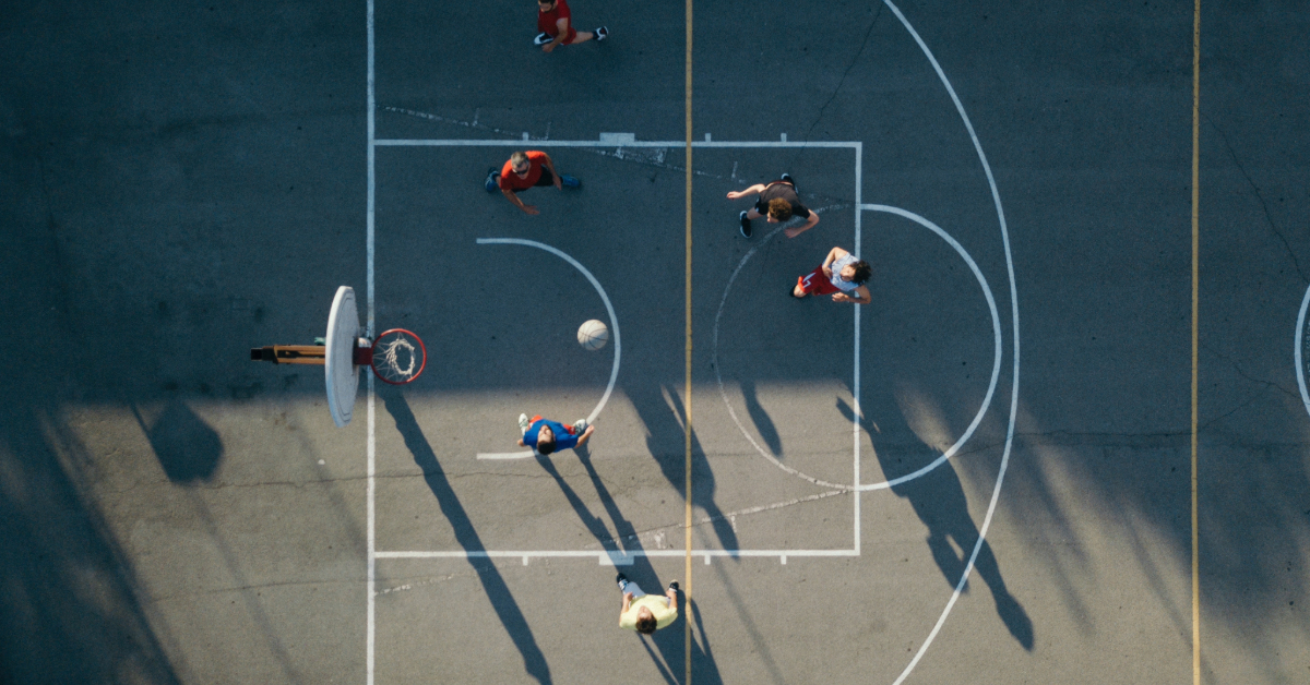 Overhead view of friends on basketball court playing basketball game