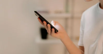 A person using UAE PASS on a smartphone for digital verification