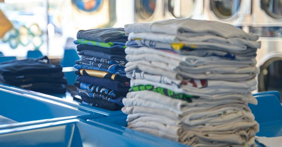 A neatly folded stack of clothes on a table