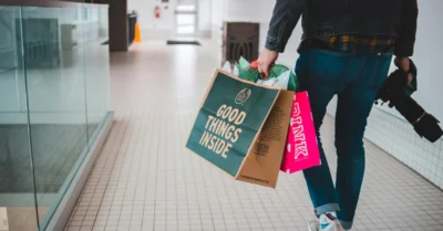 Man carrying shopping bags inside a mall