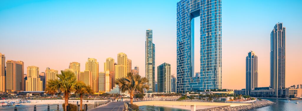 Beautiful architecture rising against the skyline along the jumeirah beach of dubai during sunset