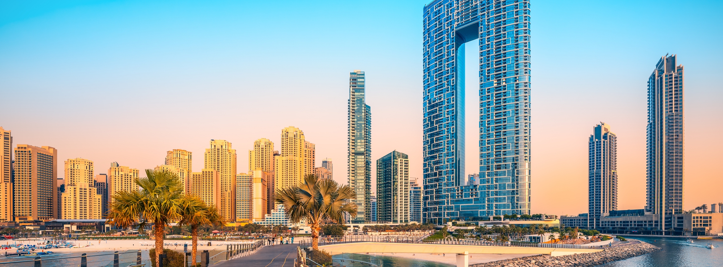 Beautiful architecture rising against the skyline along the jumeirah beach of dubai during sunset